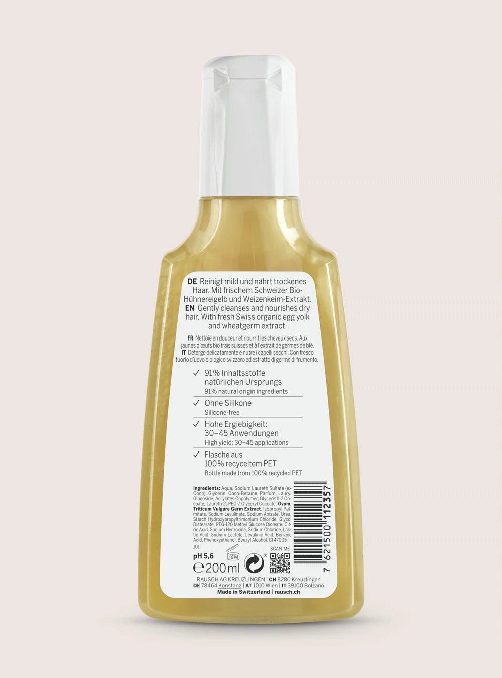 Back view of a 200ml bottle of hair care product, showing the German text label and barcode, filled with a light yellow liquid, on a solid pale pink background.