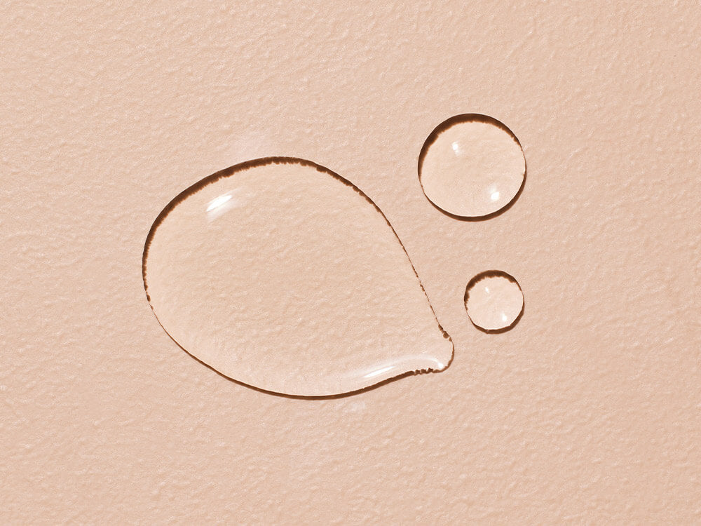 Close-up of water droplets on a beige surface