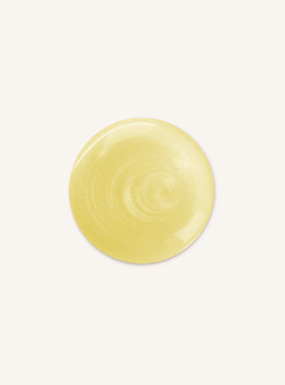 A circular swatch of pale yellow cream or gel, showing a smooth, glossy texture, centered on a solid off-white background.