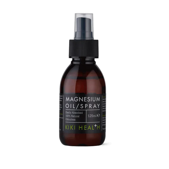 A 125ml bottle of Kiki Health Magnesium Oil/Spray in an amber glass bottle with a black spray cap and a black label featuring white and lime green text.